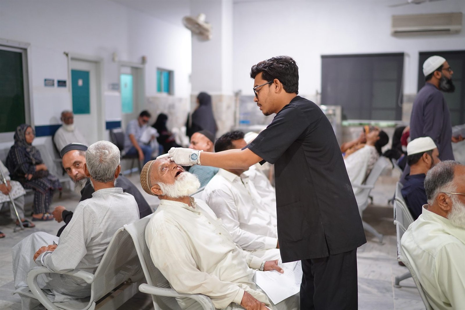 Eye drops being administered to patients in the PEBS Hospital Eye Unit ward