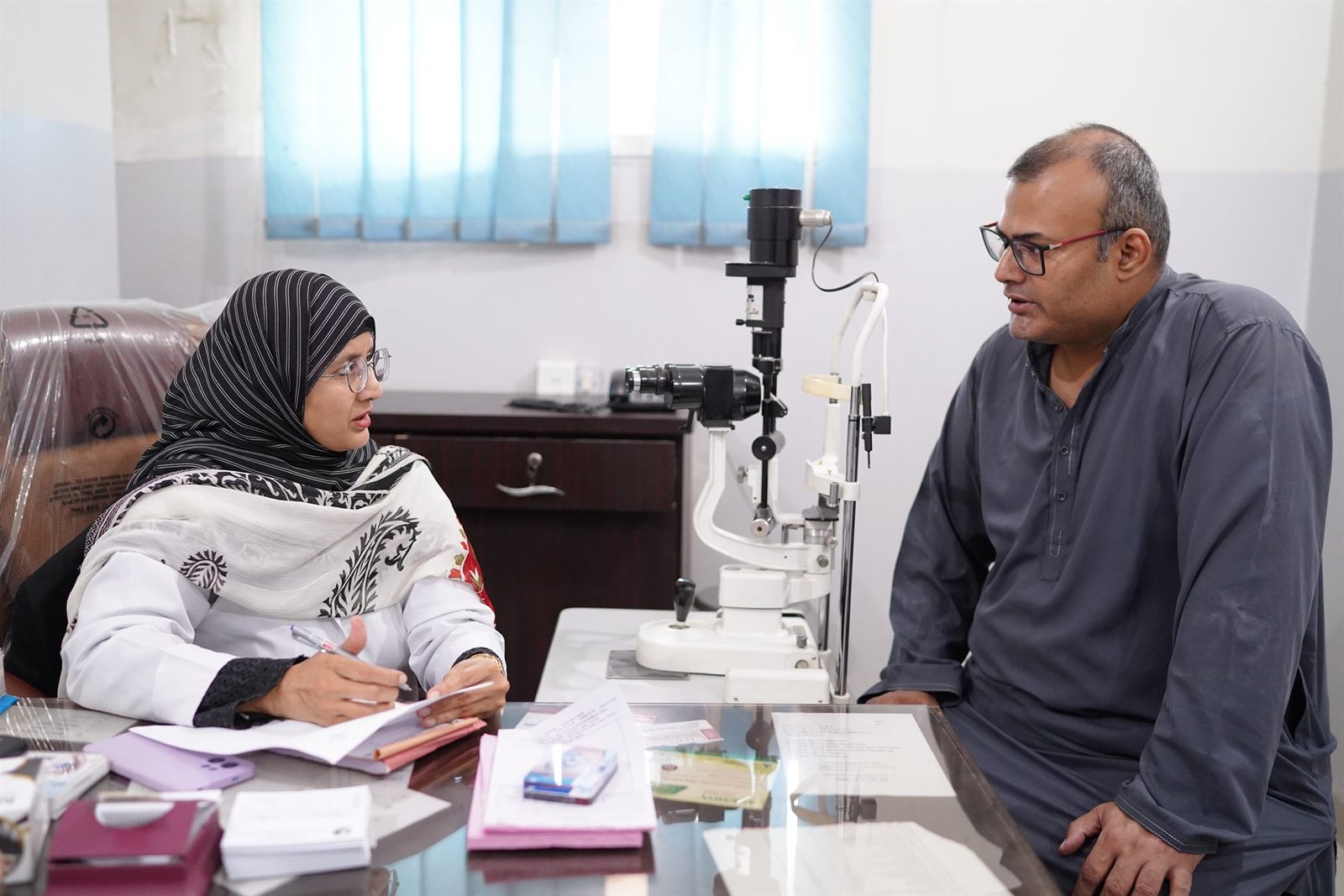 Ophthalmic consultation beside a slit lamp in the PEBS Hospital Eye Unit