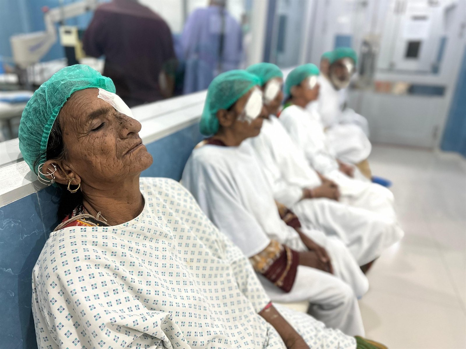 Patients with protective eye patches recovering after surgery in the PEBS Hospital Eye Unit