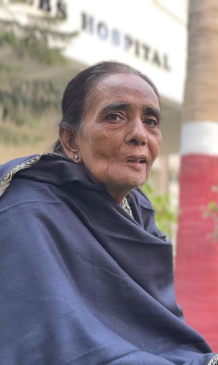 Elderly patient outside the PEBS Hospital building