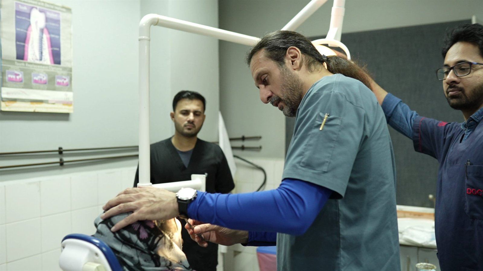 Surgeons examining a patient in the PEBS Hospital Oral Cancer Surgery Unit