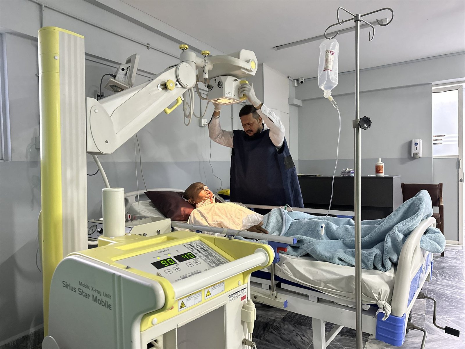 Portable X-ray machine in use at a patient's bedside at PEBS Hospital