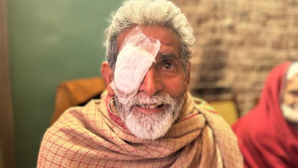 An elderly man after cataract surgery at a PEBS eye camp