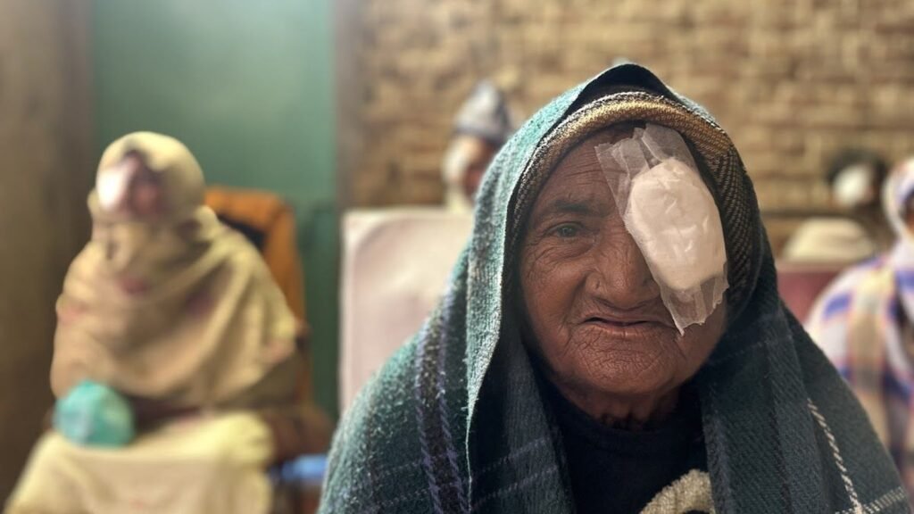 An elderly woman after eye surgery at a PEBS camp