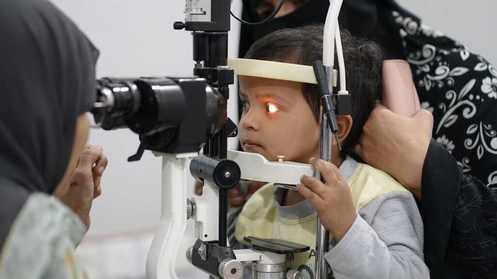 A child at the slit lamp during a PEBS eye examination