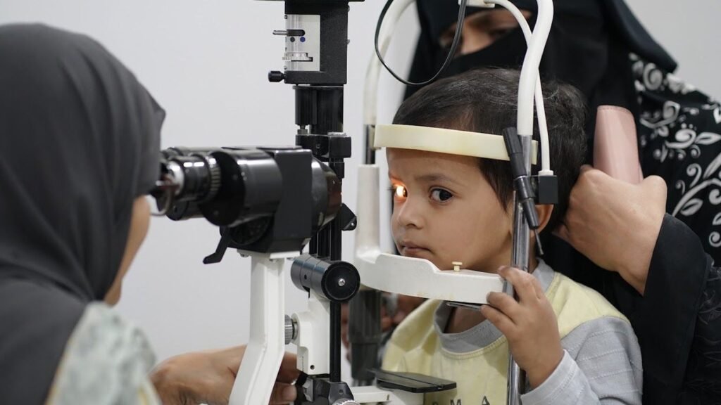 A young child being examined at the slit lamp, PEBS Hospital