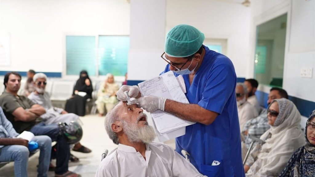 A doctor putting drops in a patient's eye at PEBS Hospital