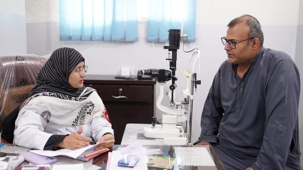 A patient at the slit lamp in the PEBS Hospital eye clinic