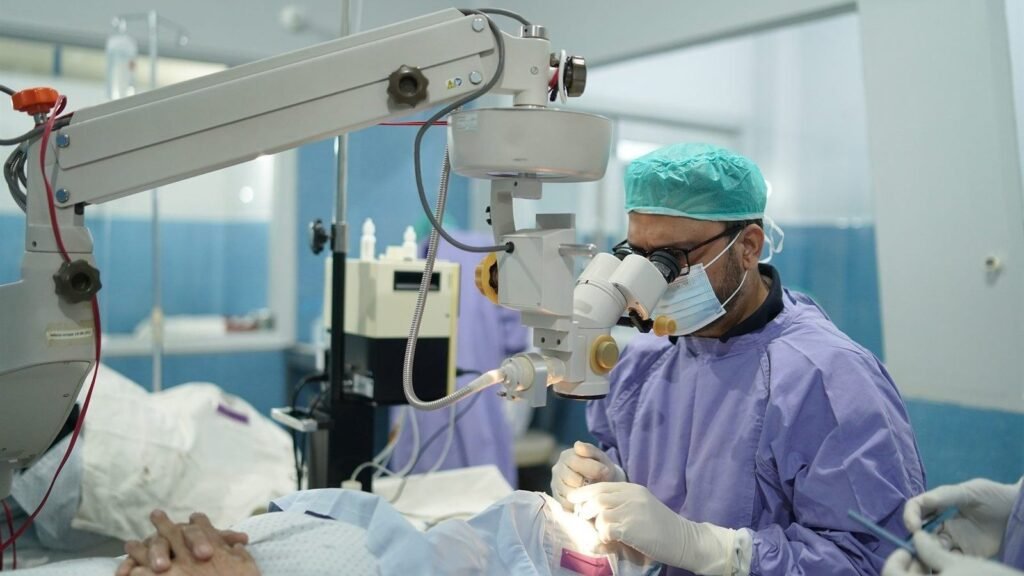 An eye operation under the microscope at PEBS Hospital
