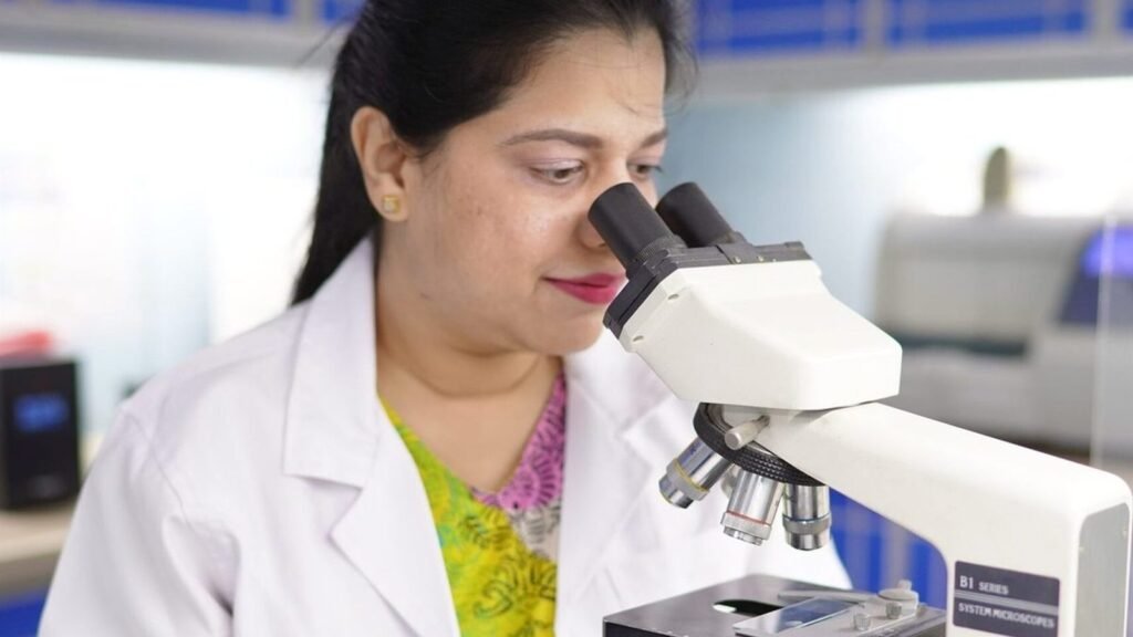 A PEBS laboratory scientist at the microscope